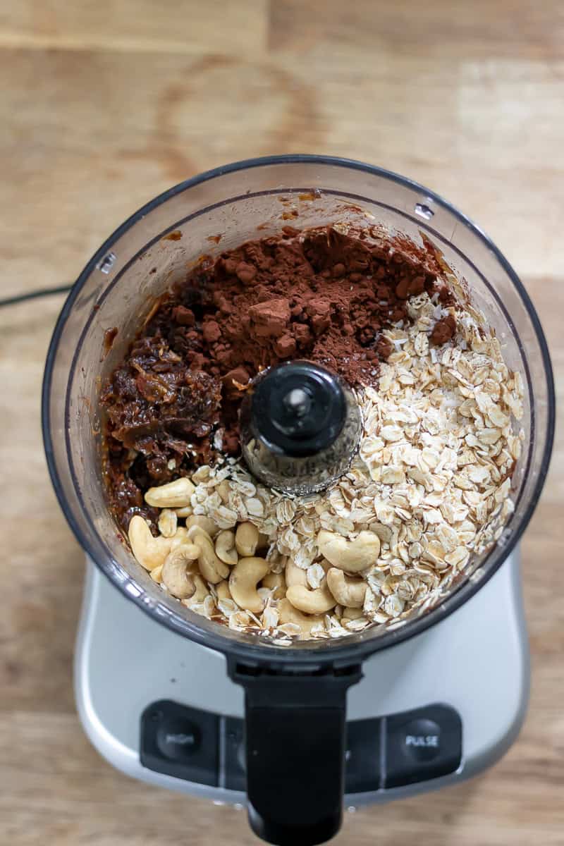 Cocoa powder, oats and cashews added to the food processor.
