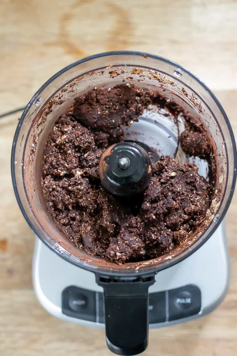 Food processor with mint chocolate energy ball mixture.