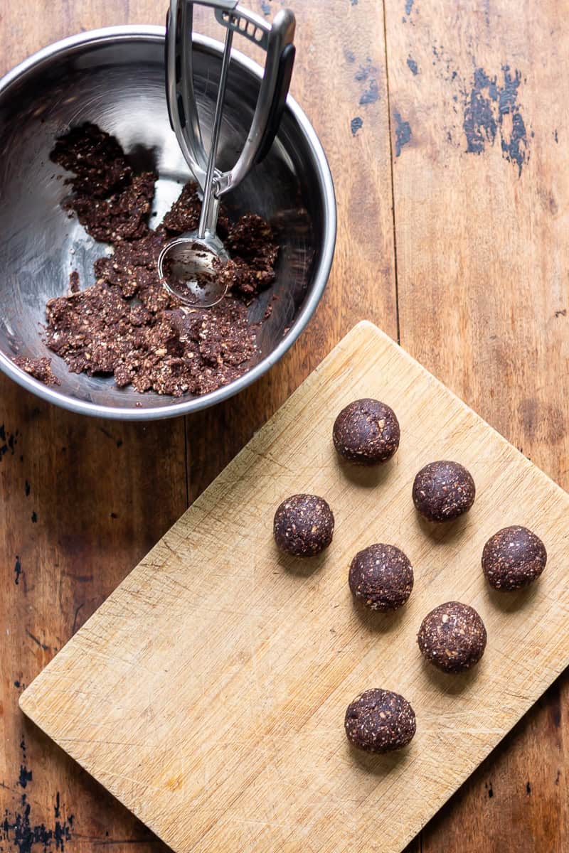 Scooping and rolling mint chocolate energy balls.