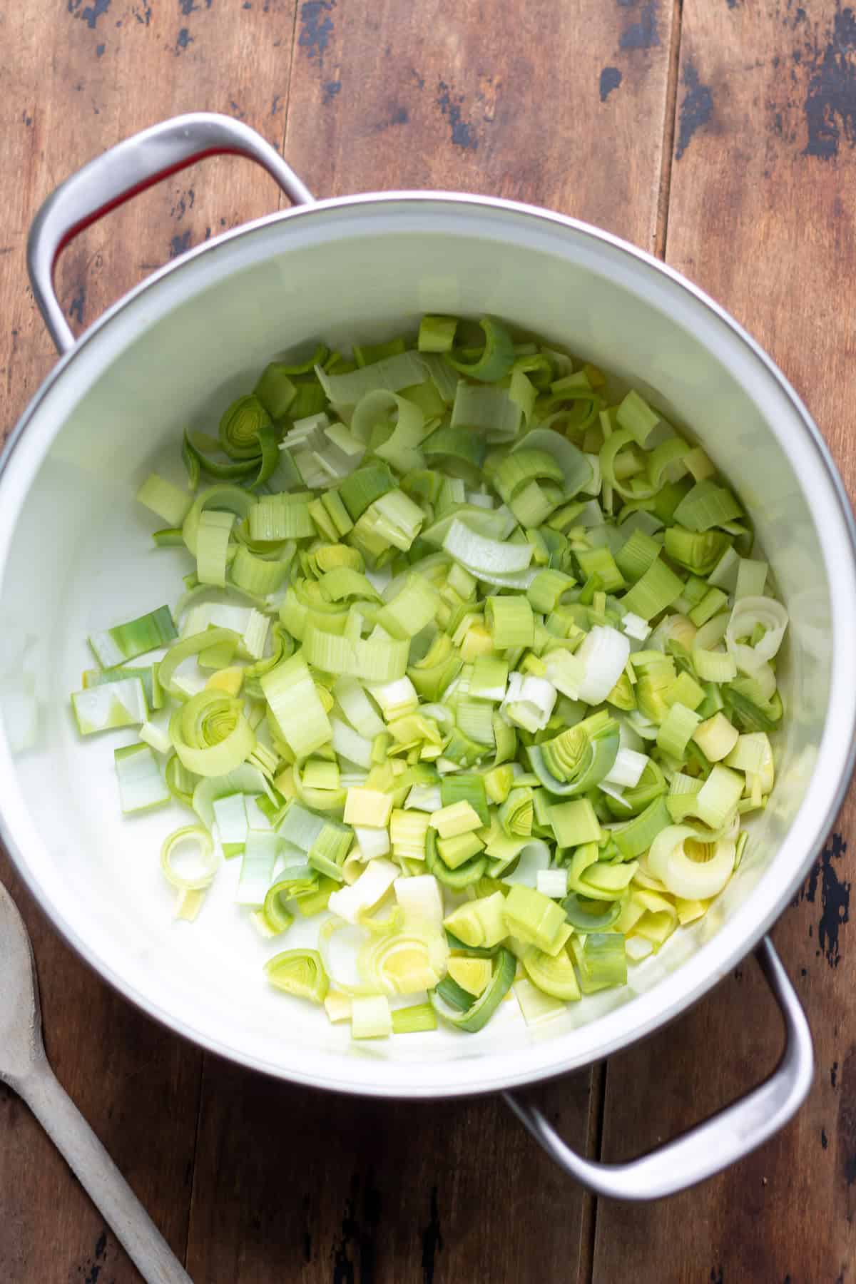 Chopped leeks in a soup pot.