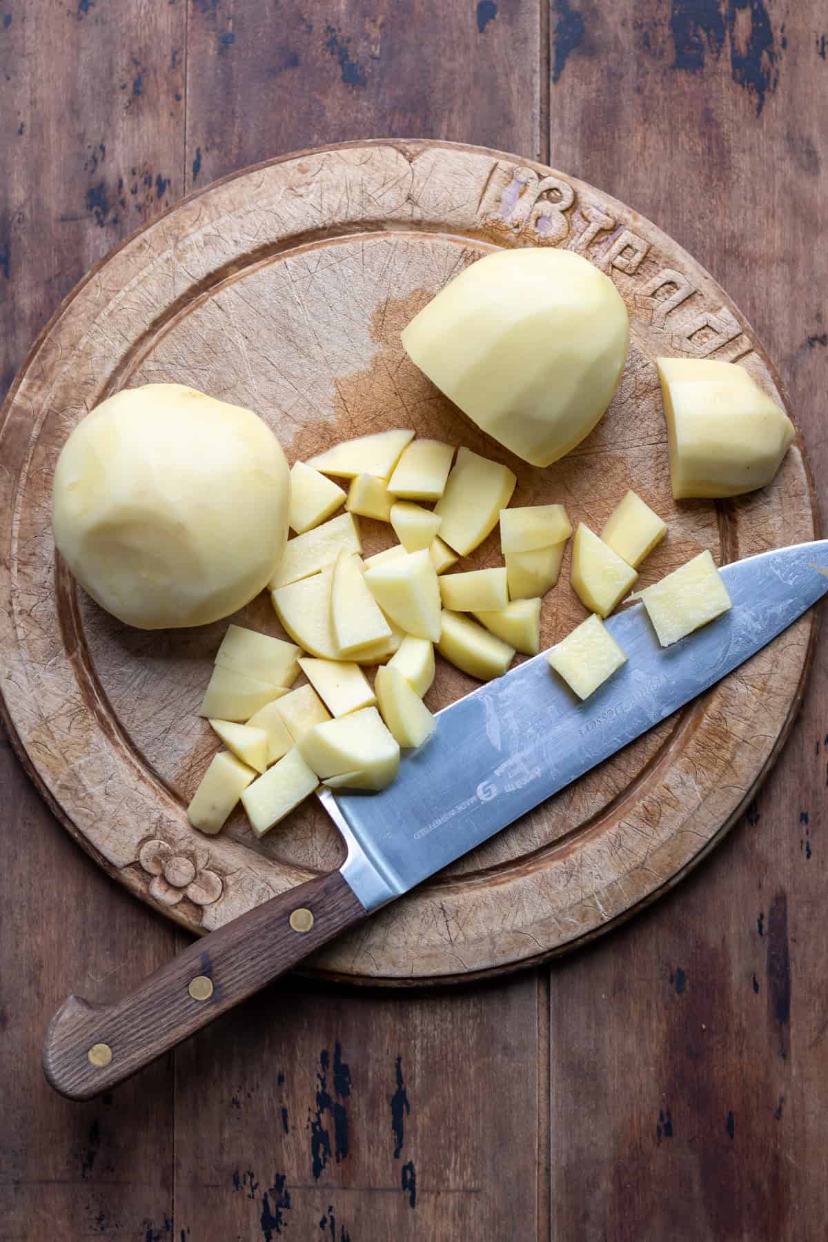 Chopping peeled potatoes.