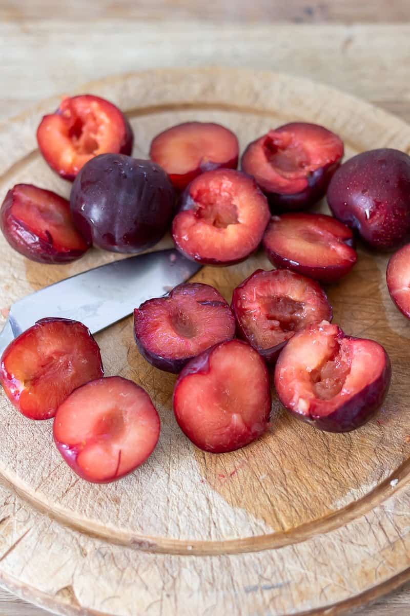 Halving and de-stoning plums.