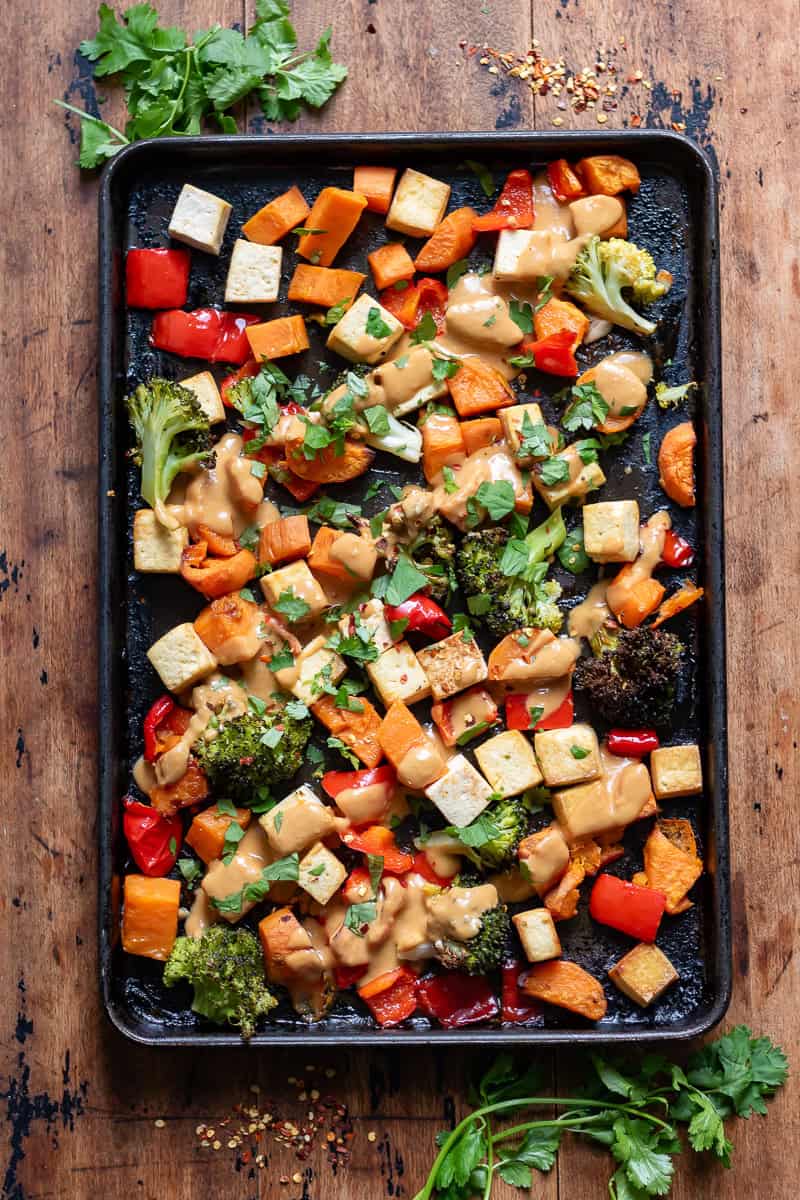 Peanut Lime Tofu Vegetable Tray Bake on a wooden table.