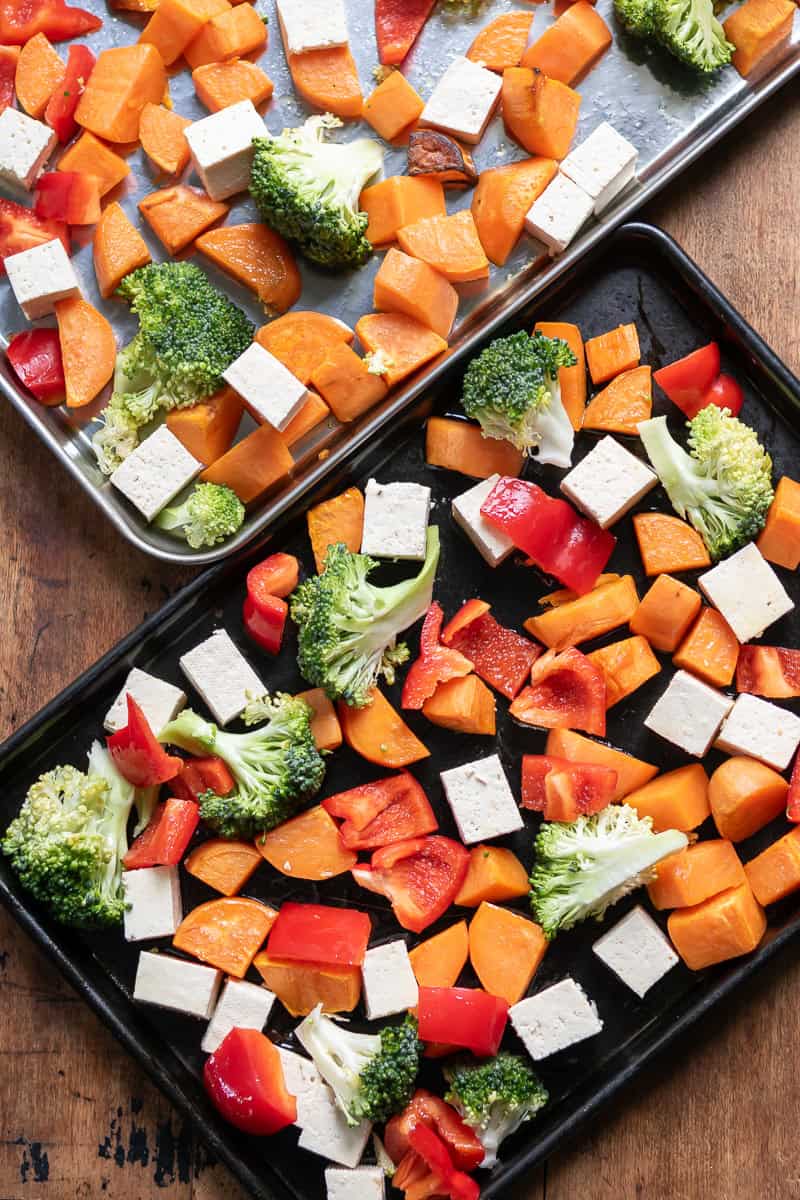 Two sheet pans with veggies and tofu.