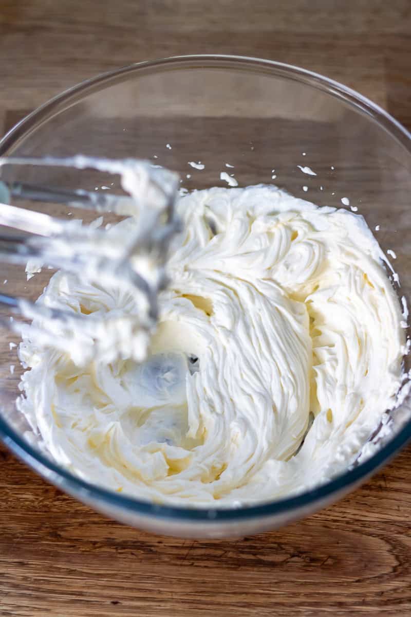 Beating the cream cheese.